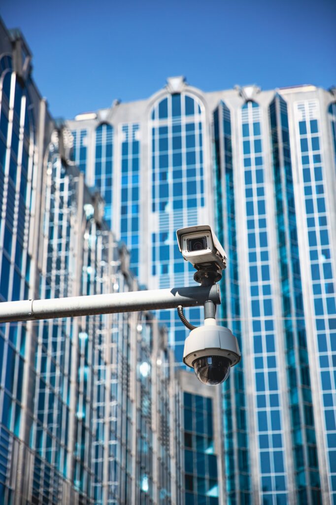 A CCTV surveillance camera in a modern city environment and office buildings