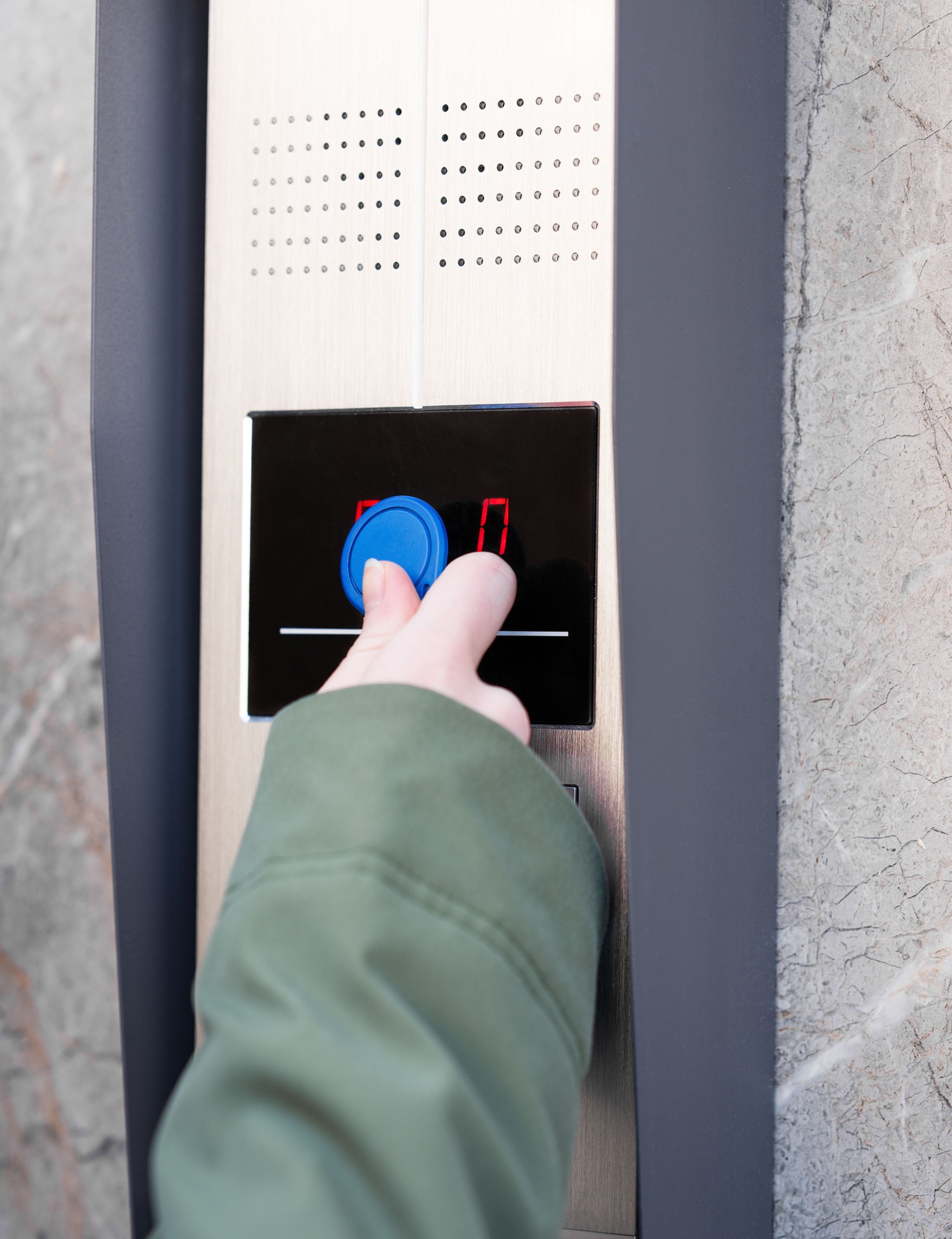 Person entering security code on keypad access control system.